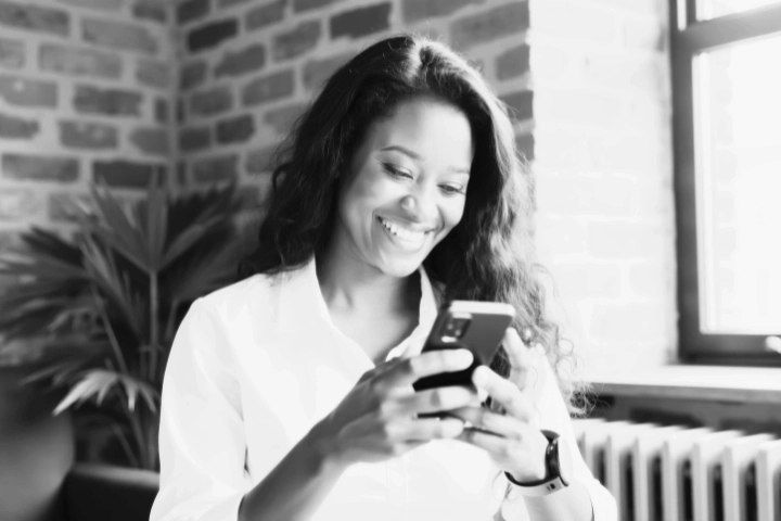 Business professional using a mobile phone to stay connected in a modern workplace.